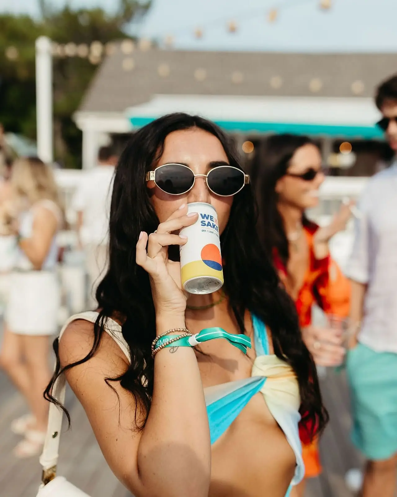 Drinking WESAKE from the can at a beach party