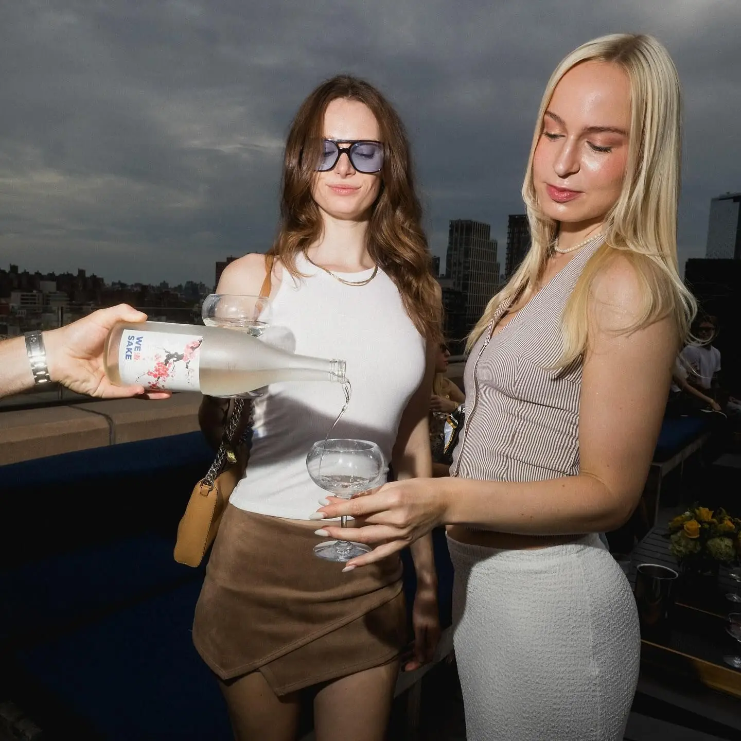 Pouring the WESAKE Sakura bottle on a New York rooftop