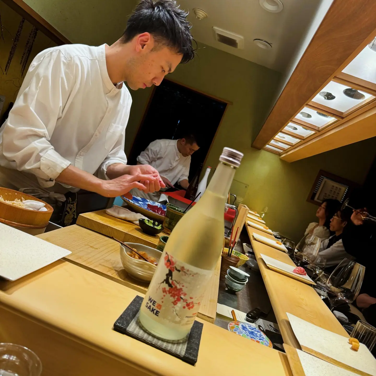 The WESAKE Sakura bottle at a sushi counter