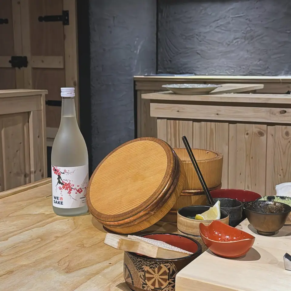 The WESAKE Sakura bottle at an omakase counter