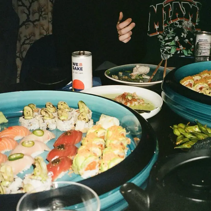 A WESAKE can next to a sushi platter